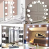 A round dimmable LED vanity mirror with multiple lights reflecting a room interior.