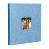 A blue linen scrapbook memory book with a photo of a family standing together.