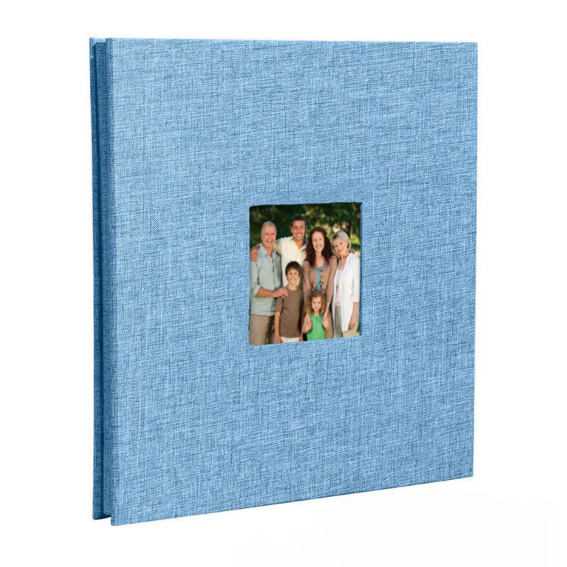A blue linen scrapbook memory book with a photo of a family standing together.