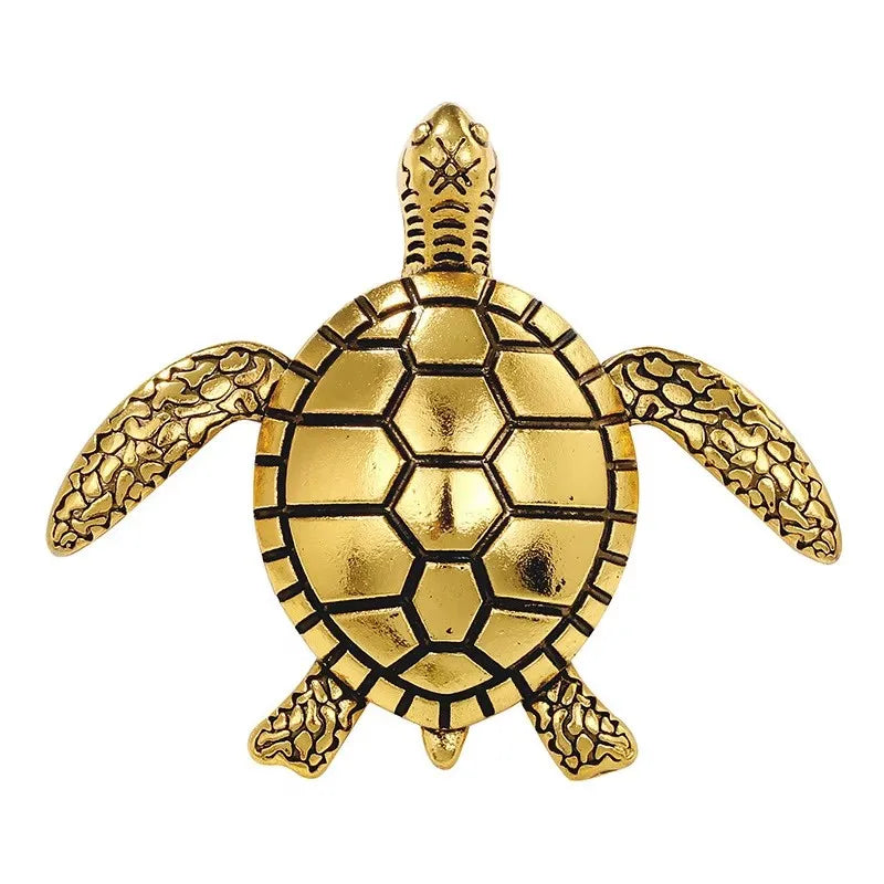A vintage gold-colored brooch pin set shaped like a sea turtle.