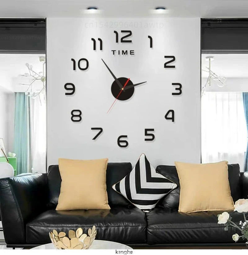 A modern wall clock with black numbers and hands is displayed above a black sofa.
