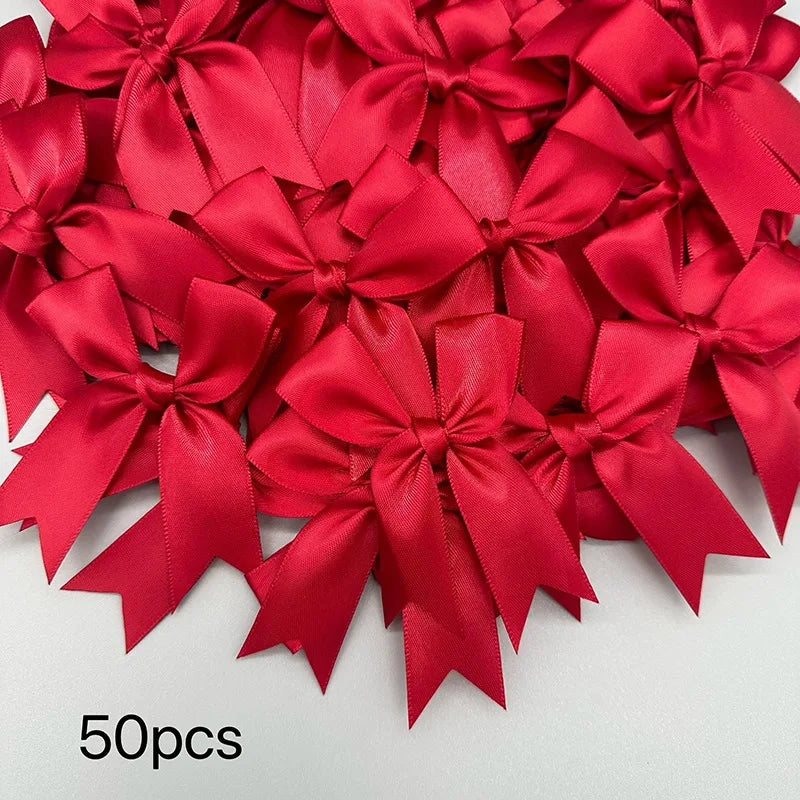 A close-up view of 50 elegant red satin ribbon bows for gift wrapping and decor.