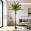 An artificial golden palm tree standing in a modern living room with natural light.