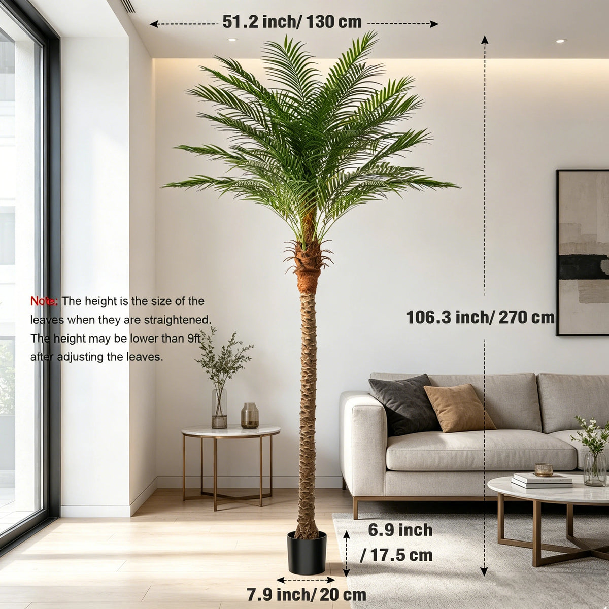 An artificial golden palm tree standing in a modern living room with natural light.