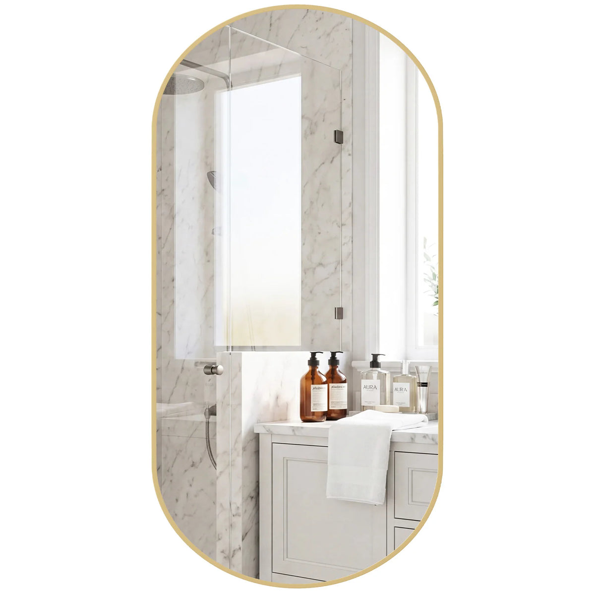 An oval wall mirror with a metal frame reflecting a bathroom interior and bottles.