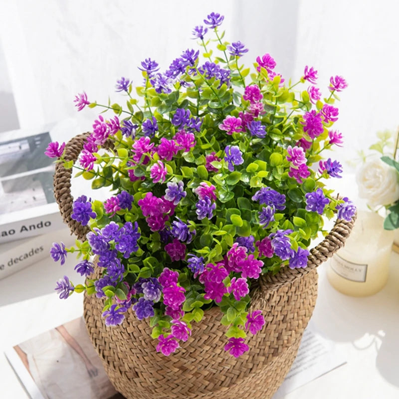 A vibrant bouquet of purple and pink artificial eucalyptus branches in a woven basket for home decor