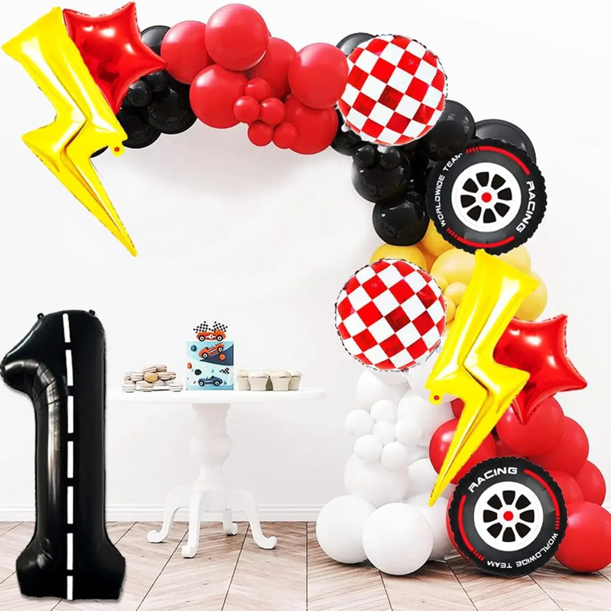A large arch made of red and black balloons, including a yellow lightning bolt shape, for a birthday party decoration.