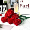 A bouquet of red silk rose building blocks displayed on a white surface.