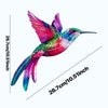 A vibrant, iridescent hummingbird sculpture in pink, green, and blue hues displayed against a white background.