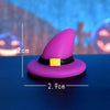 A purple resin craft miniature witch hat with a black band and yellow accent, shown against a blue background.