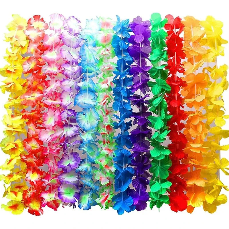 A vibrant display of colorful tropical flower leis in various shades of red, orange, yellow, green, blue, and purple.