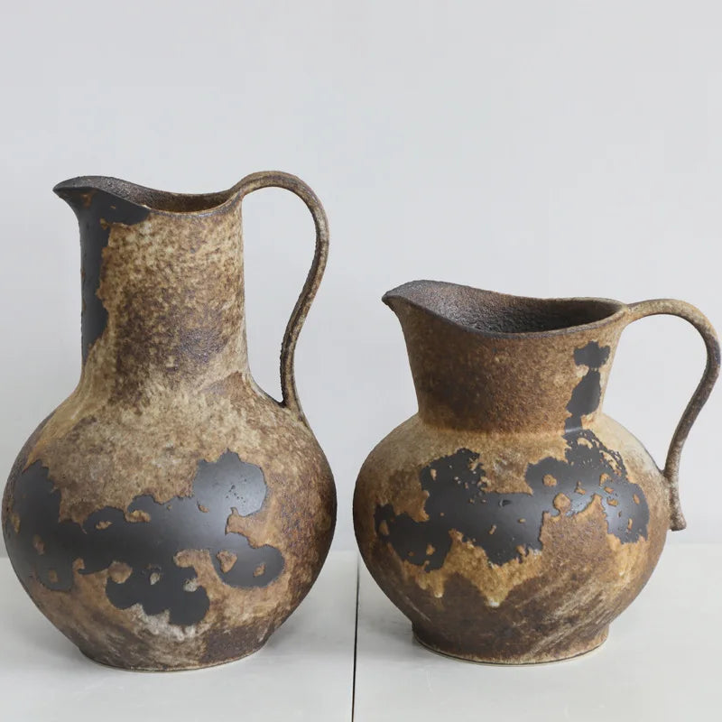 A vintage dual-sided ceramic vase with a mottled brown and black glaze, shown from the side.