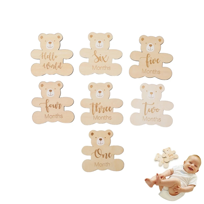 A set of wooden baby milestone cards featuring bear designs for months like five, six, four, three, two, and one.