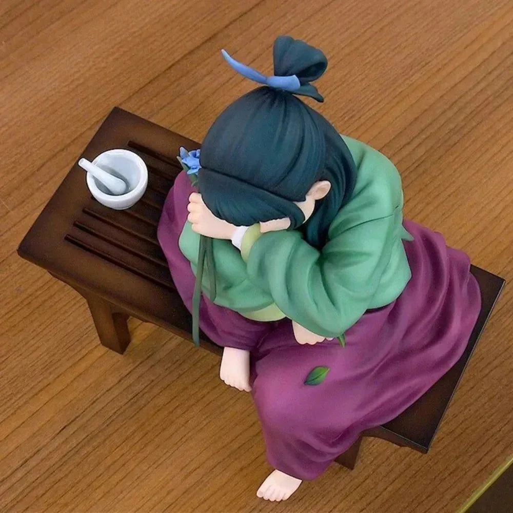 A collectible PVC figure of Maomao from The Apothecary Diaries, depicted in a purple kimono with green sleeves.