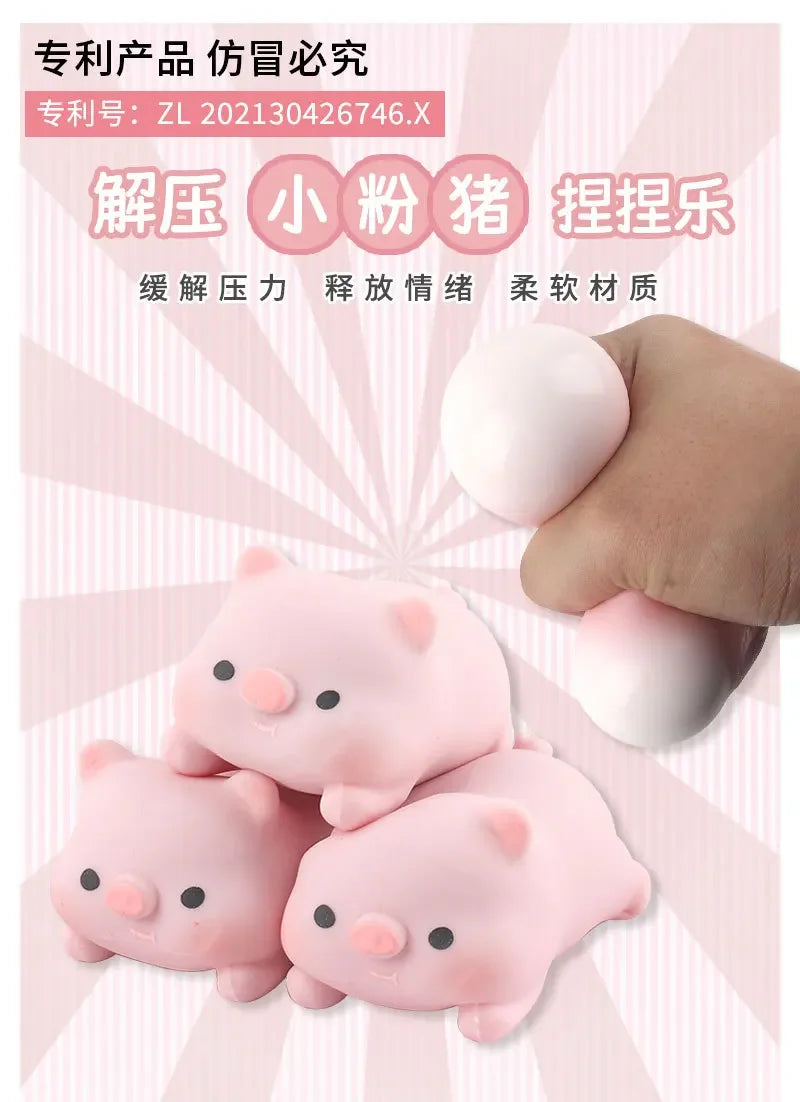 A hand holds several pink pig-shaped squishy toys used for stress relief and muscle relaxation.