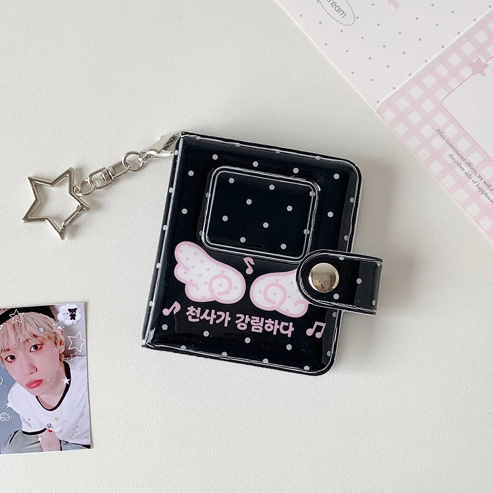A black mini snap button photo album with a silver chain, featuring a K-pop card inside.