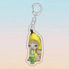 A yellow cat holding a green drink, attached to an acrylic keychain.