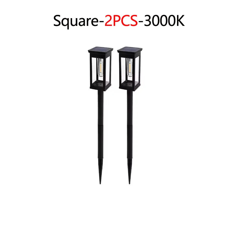 Two black square solar pathway lights with illuminated bulbs.