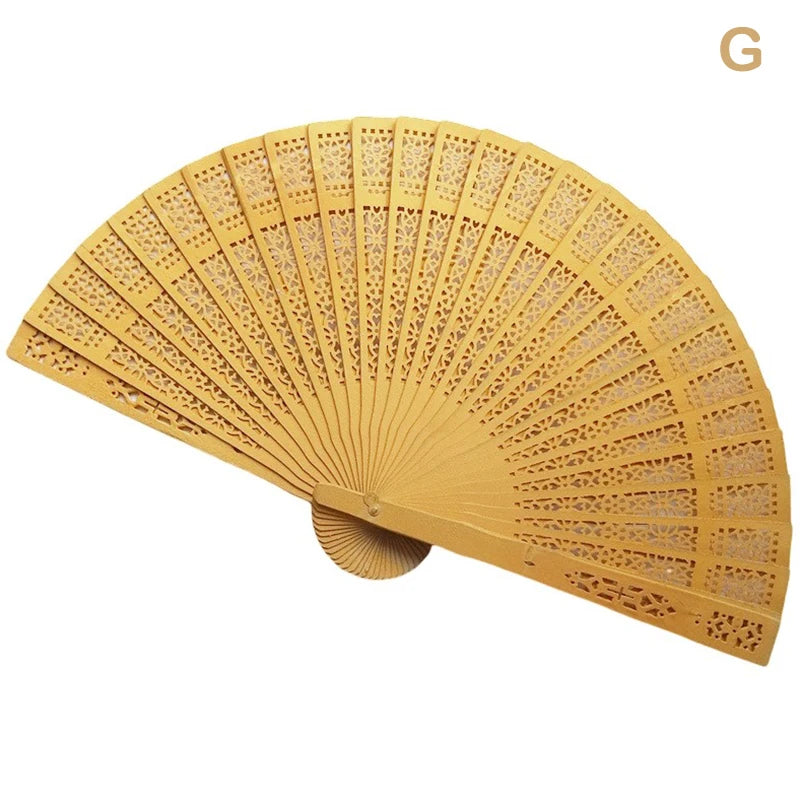 Hand carved bamboo folding fan with a light yellow color shown in an open, semi-circular display.