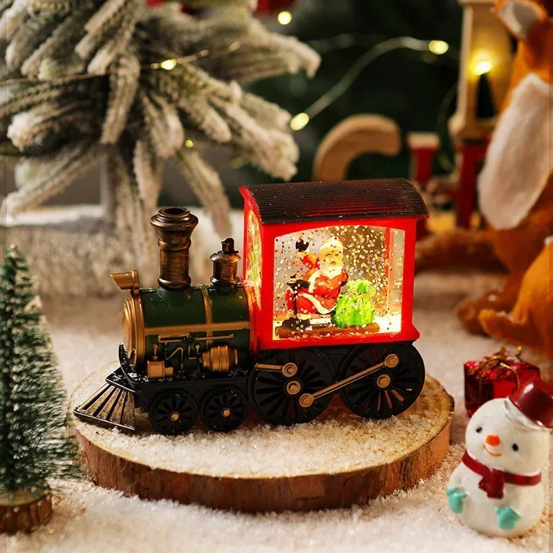 A miniature Christmas train with LED lights and a water-filled crystal ball displayed on a wooden surface.