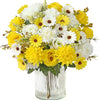 A vibrant bouquet of yellow and white artificial silk roses and daisies in a clear glass vase.