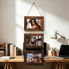 A set of three rustic wooden photo frames displayed vertically on a light-colored wall.
