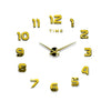 A modern 3D acrylic wall clock face with gold-colored numbers displaying the time.