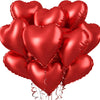 A cluster of shiny red heart-shaped foil balloons.