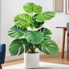 Artificial Monstera plant with silk green leaves in a white pot for home decor