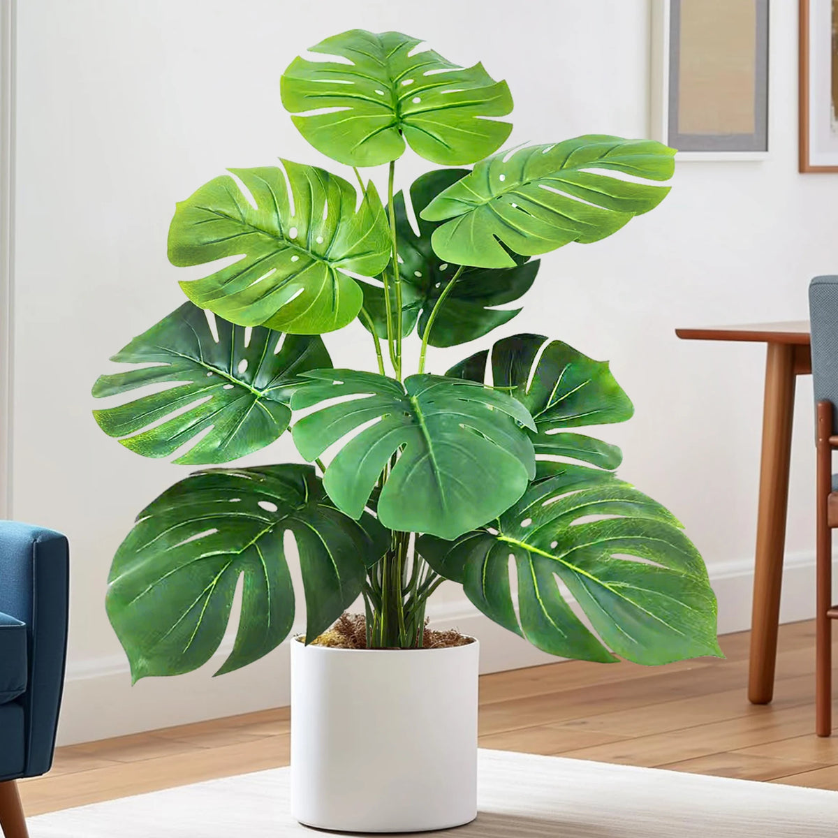 Artificial Monstera plant with silk green leaves in a white pot for home decor