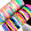 A stack of silicone bracelets featuring the Jesus heart design in various bright colors.