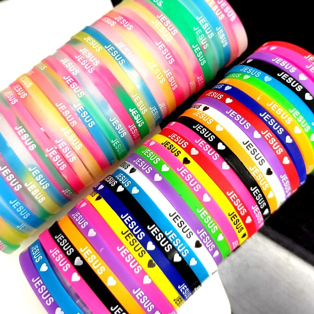 A stack of silicone bracelets featuring the Jesus heart design in various bright colors.
