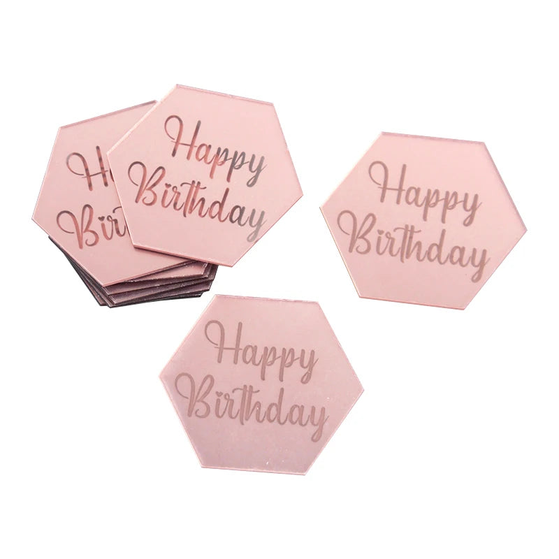 A set of ten pink hexagonal acrylic birthday toppers with the text Happy Birthday