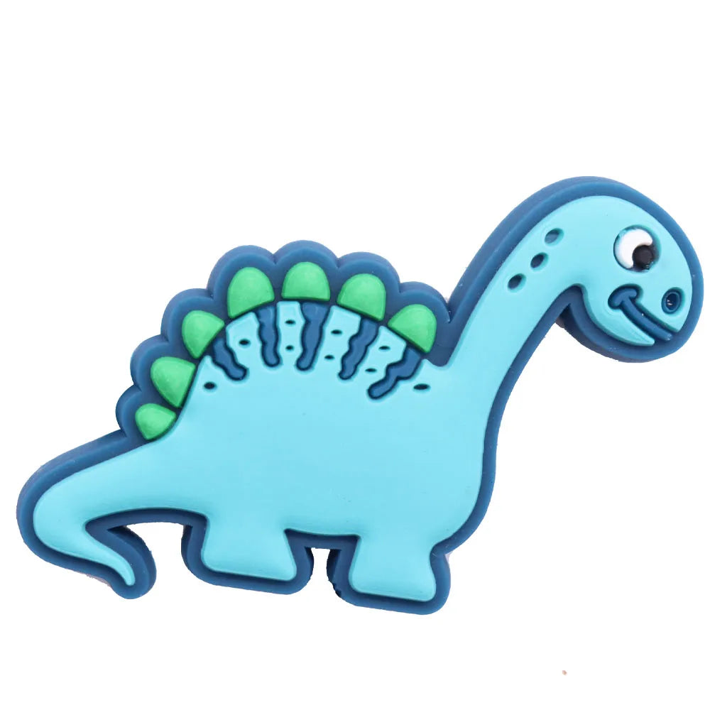A set of twelve cartoon dinosaur PVC shoe charms featuring blue skin and green spines.