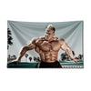 A muscular man posing intensely in a bodybuilding gym flag against a muted background.