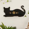 A black silhouette of a cat with gold moon phases and sun decoration on a white background.