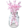 A glass jar filled with pink and white striped straws tied into bows for a birthday party supply set.