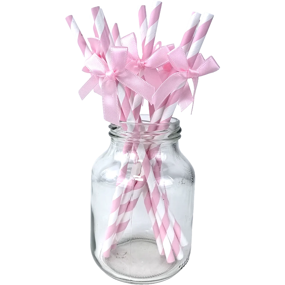 A glass jar filled with pink and white striped straws tied into bows for a birthday party supply set.