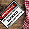 A black and white warning sign with red text that reads Warning Behind This Door I May Or May Not Be Naked