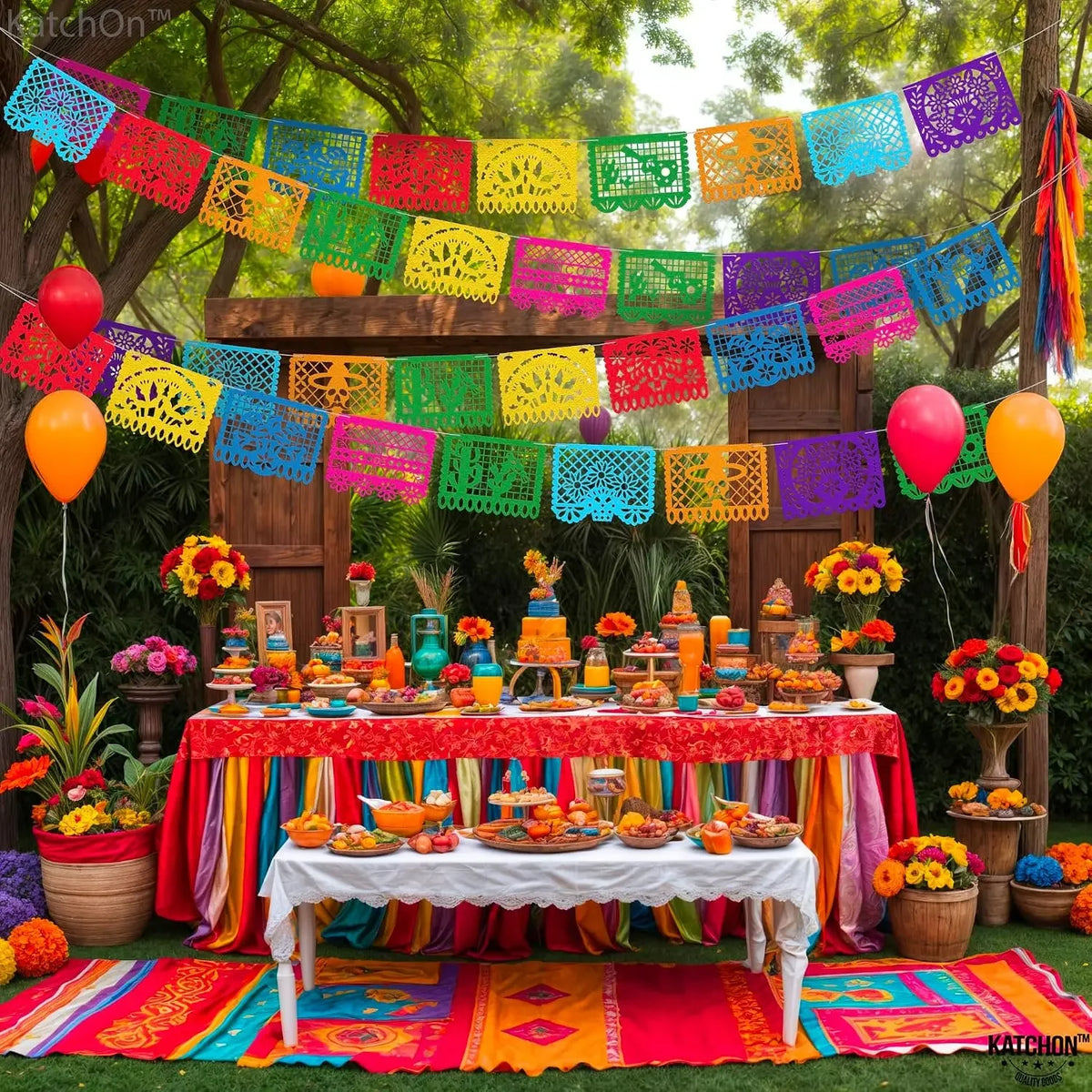 A colorful papel picado bunting banner decorated with flowers and fruit for a Mexican celebration.
