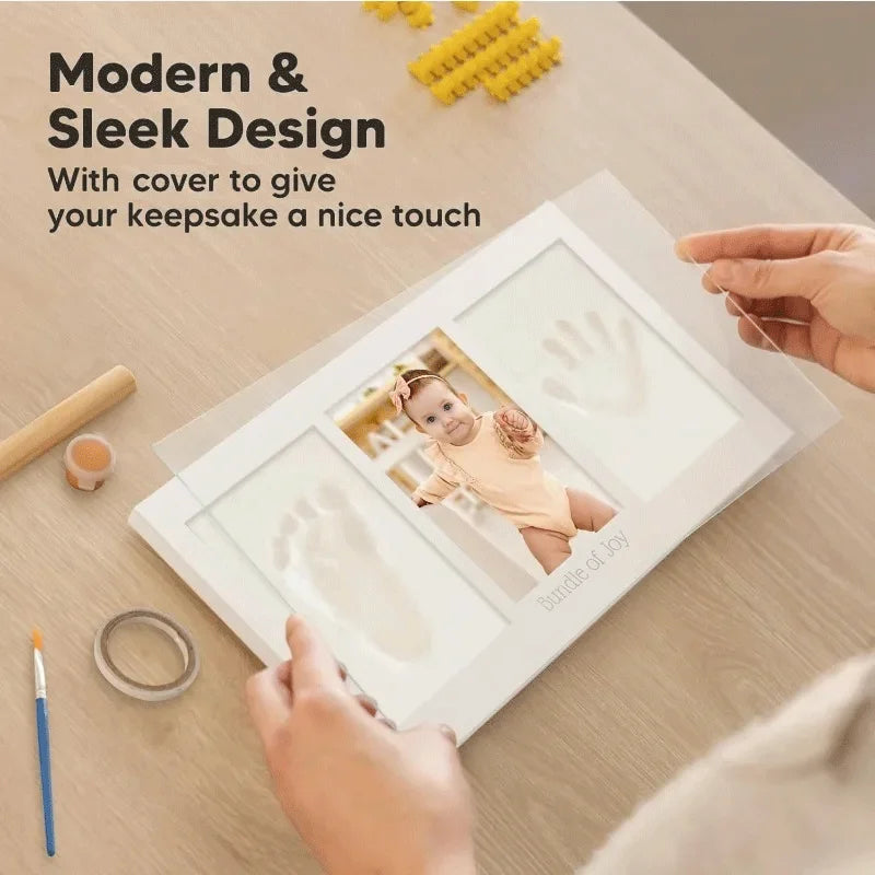 A handprint and footprint keepsake frame kit with a cover, showing a baby's handprint and footprint.