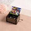 A hand-cranked wooden music box featuring Totoro characters set in a decorative wooden box.