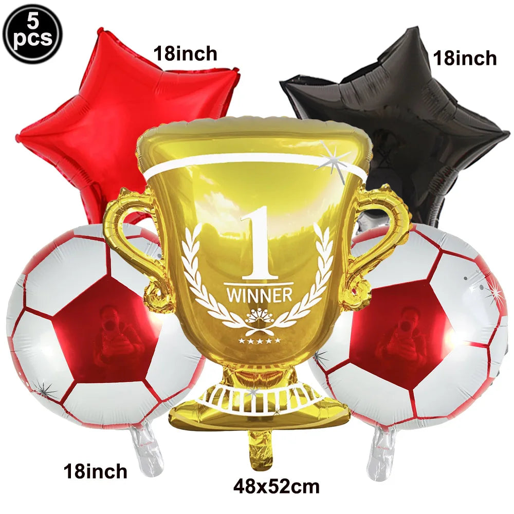A set of five inflatable soccer balls and a gold trophy balloon for a party decoration