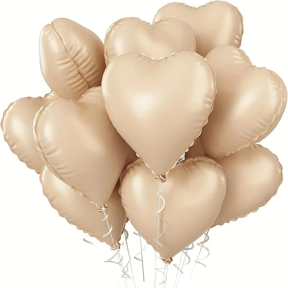 A cluster of ten light gold heart-shaped foil balloons tied together for a celebration.