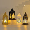 A collection of elegant LED star and moon lanterns glowing warmly on a white surface.