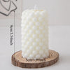 A white Nordic bubble scented soy candle is displayed on a wooden coaster.