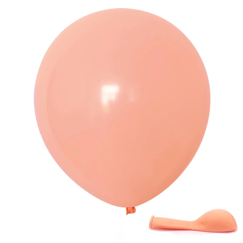 A single light pink balloon and a small orange spatula are shown against a white background.