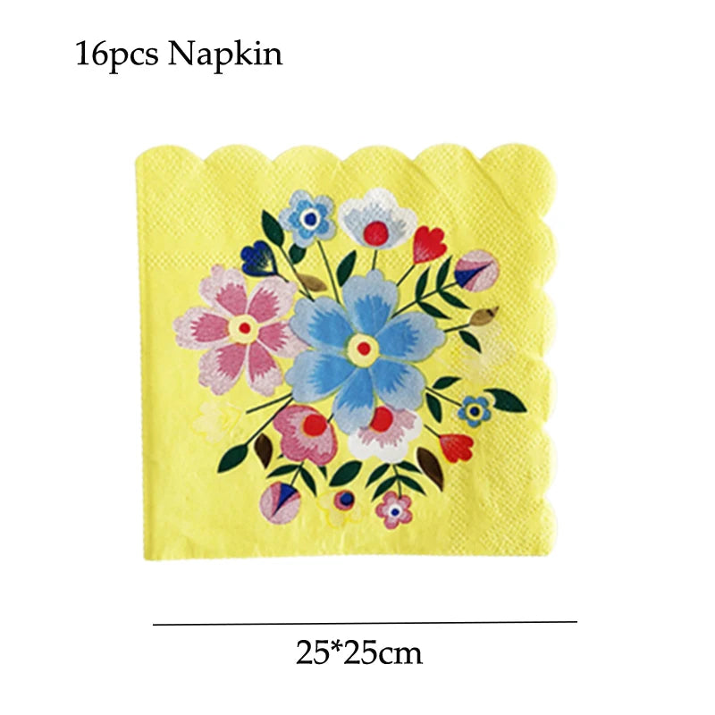 A yellow napkin featuring a colorful floral pattern with blue, pink, and red flowers.