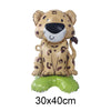 A foil balloon shaped like a leopard or cheetah head with brown and black spots, sitting on a green balloon base.