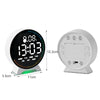 A white LED ambient light alarm clock displaying the time and jumping seconds on a circular screen.